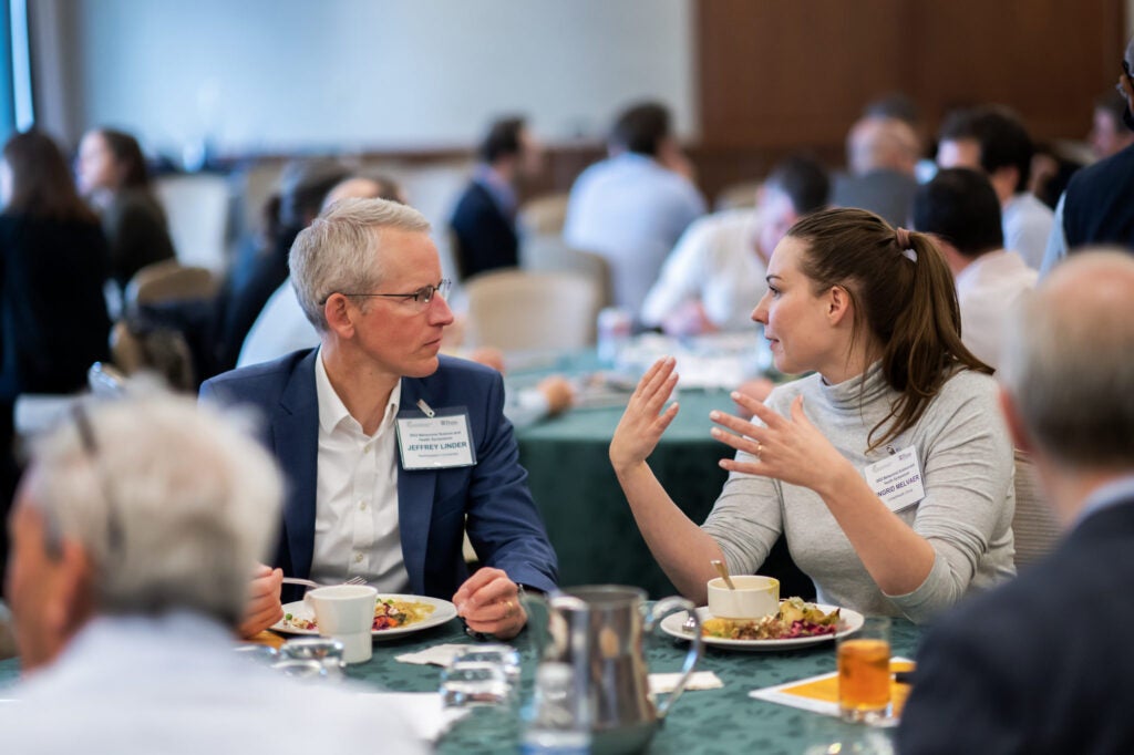 Attendees chat at CHIBE's Behavioral Science and Health Symposium