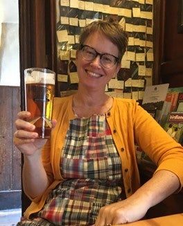 Dr. Alison Buttenheim drinking a pint in Oxford.