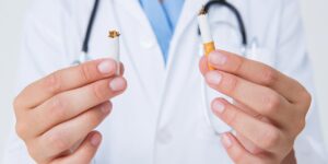 doctor holding cigarette ripped in half