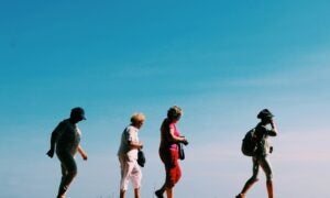 women walking with blue sky behind them