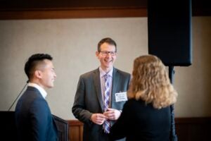 Dr. Noah Goldstein speaks with symposium attendees.